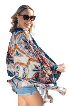 Love to layer all of your look in this bohemian-inspired duster that is covered in a bright medallion pattern. Open front Short sleeves 100% rayon Hand wash, line dry Imported Model stats: 5'10", 32" bust, 25" waist, 36" hip. Model is wearing size One Size. Bohemian Floral Print Outerwear For Vacation, Bohemian Floral Print Vacation Outerwear, Bohemian Outerwear For Beach, Bohemian Floral Print Outerwear For Beach, Bohemian Printed Summer Outerwear, Bohemian Outerwear With Floral Print For Beach, Multicolor Boho Print Outerwear For Festivals, Multicolor Boho Print Festival Outerwear, Bohemian Multicolor Outerwear For Vacation