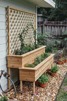 a wooden planter filled with lots of plants