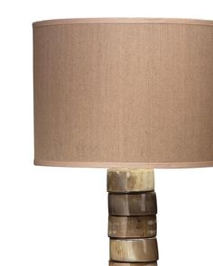 a lamp that is made out of wood and has a beige shade on the top