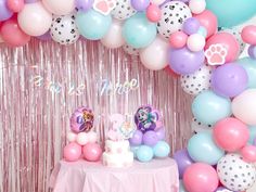 there is a cake and balloons in front of the backdrop for this birthday party decoration