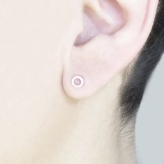 "These cute little organically shaped circles are hand crafted from solid 14k gold and your choice of sterling silver or solid 14k gold posts. Perfect for everyday wear, their understated matte finish adds just enough of a glimmer to complement any outfit. The tiny size also makes these perfect for second and third piercings. Priced per pair. Each 14k circle measures 5mm (~.1 inch) in diameter. Studs are mounted on either standard 20-gauge, nickel-free sterling silver or solid 14k yellow gold po Dainty Polished Everyday Earrings, Dainty Everyday Earrings With Polished Finish, Minimalist 14k Gold Halo Jewelry, Minimalist 14k Gold Jewelry With Halo Design, 14k Gold Open Circle Earrings Gift, Minimalist Rose Gold Circle Earrings, Everyday Minimalist Jewelry With Halo Design, Hypoallergenic Rose Gold Sterling Silver Jewelry, Minimalist Sterling Silver Halo Earrings