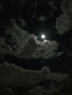 the moon is shining brightly in the night sky with clouds and trees around it,