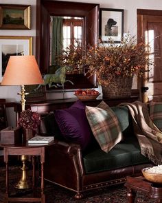 a living room filled with lots of furniture and flowers on top of a coffee table