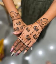 a woman's hands with hendi tattoos on them