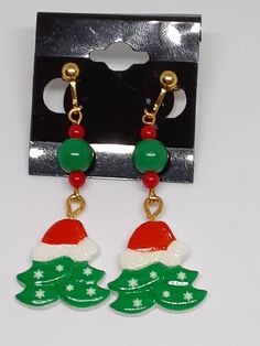 These festive earrings are made with gold tone materials. Be sure to check out my other items too. Christmas Celebration Jewelry Drop Earrings, Christmas Celebration Drop Earrings Jewelry, Christmas Celebration Jewelry With Matching Earrings, Holiday Jewelry With Matching Earrings, Gold Earrings For Holiday And New Year, Gold Earrings For New Year Holiday, Festive Christmas Jewelry With Matching Earrings, Holiday Dangle Jewelry With Matching Earrings, Nickel-free Jewelry For Festive Holidays