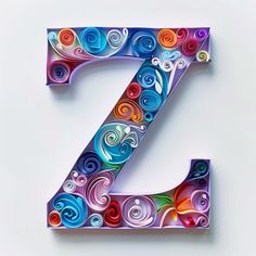 the letter z is made up of colorful paper quirky swirls and has been cut into smaller pieces