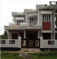 a large white house with black and red accents