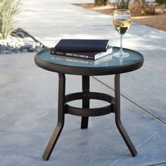 a glass of wine sitting on top of a table next to a book and some books