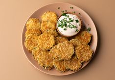 some fried food on a plate with ranch dressing