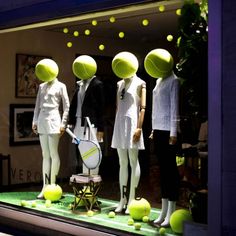 mannequins dressed in white with tennis balls and rackets