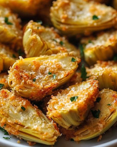 artichokes with parmesan cheese and herbs on a plate