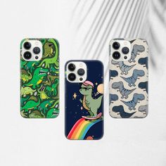 three phone cases with dinosaurs on them, one is green and the other is blue