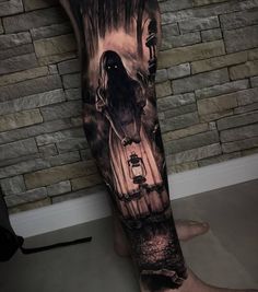 a man's arm with a tattoo on it that has a black and white image of a ghost