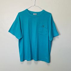 "Adult L Poly cotton blend 46\" chest 25\" length Awesome vintage cerulean blue 80s tee with a button pocket at the chest. Very soft and comfy, in great vintage condition with no noticeable flaws" Blue Crew Neck T-shirt With Pockets, Light Blue Tops With Pockets For Everyday, Vintage Crew Neck Top With Pockets, Blue T-shirt With Pockets And Short Sleeves, Vintage Washed Blue Tops With Pockets, Kittens Vintage, 80s Tees, Blank Crewneck, 90s Denim