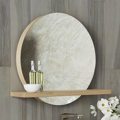 a bathroom with a sink, mirror and vase on the shelf in front of it