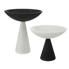 two black and white vases sitting next to each other