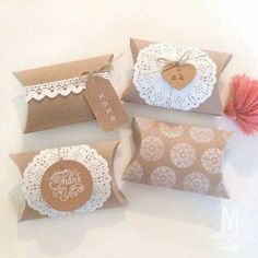 four brown and white paper bags with doily on them, one has a tag that says thank you