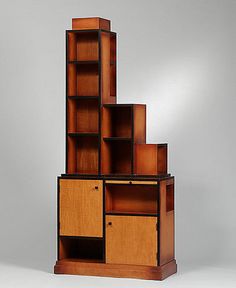 a tall wooden bookcase with drawers and shelves