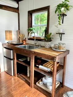 a kitchen area with sink, dishwasher and refrigerator