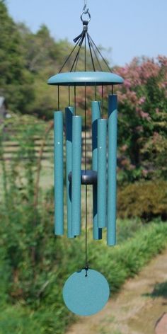 a blue wind chime hanging from the side of a window next to a road