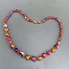 Vintage ~ handmade ~ Italian Millefiori glass beaded necklace ~ All beads are hand knotted with barrel clasp at the end ~ Colorful glass beads . Dates mid to late 20th century ~ Unsigned Materials : Glass beads gold tone metal Measurements : Necklace is 16 1/2 inches in length x 1/2 inches max width . Smallest Bead is 1/4 inches in diameter and largest is 1/2 inches in diameter . Condition : Good vintage condition ~ No major cracks or chips to any of the glass beads ~ Clasp is in good working or Murano Glass Polished Bead Necklaces, Murano Glass Beaded Necklace With Polished Beads, Colorful Murano Glass Beaded Necklaces, Glass Bead Necklaces 8mm, Glass Bead Necklaces With 8mm Round Beads, Glass Necklaces With 8mm Round Beads, Round Polished Murano Glass Beaded Necklace, Round Glass Beads For Jewelry Making, Round Glass Beaded Necklace With Spacer Beads