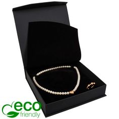 a necklace in a black box with a gold clasp on the end and a white pearl bea