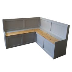 a corner kitchen bench with built - in cabinets and cupboards on the side, viewed from the front