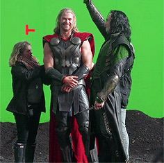 three people dressed as thor and loki in front of a green screen