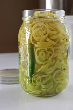 a jar filled with yellow noodles on top of a table