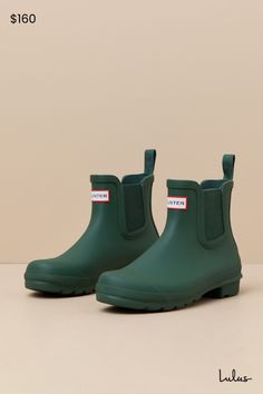 Romanticize rainy days with every step in the Hunter Original Hunter Green Chelsea Rain Boots! These matte rubber rain boots feature a rounded upper that rises to an ankle-high shaft with elastic gussets at the instep and outstep. The slip-on design features a pull tab and a ribbed-textured detail at the back, all atop a sturdy low-block heel. Logo tag at the front. Available in whole sizes only. 0. 75" rubber heel. Lightly cushioned insole. Rubber sole has nonskid markings. Man made materials. Green Hunter Boots, Ankle Rain Boots, Winter Shoes