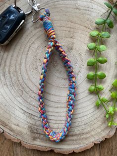 a multicolored lanyard with a car keychain on top of it