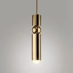 a gold colored pendant light hanging from a ceiling