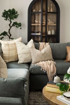 a living room filled with furniture and pillows