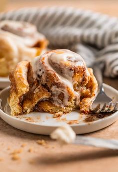 cinnamon roll on a plate with a fork