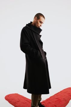 Step into timeless elegance with the Wool Long Coat, a classic piece that sophisticates any wardrobe. This coat is crafted from high-quality wool, providing warmth and a luxurious feel. The long, tailored silhouette offers a flattering fit, perfect for layering over both casual and formal outfits. The coat includes thoughtful details like a notched lapel, button closure, and spacious pockets, adding style and functionality. Whether worn over a suit for a polished office look or paired with jeans Black Wool Coat With Concealed Placket For Winter, Timeless Formal Wool Coat For Fall, Timeless Black Long Coat, Timeless Black Wool Outerwear, Timeless Long Wool Coat, Modern Black Wool Coat For Formal Occasions, Classic Wool Outerwear With Shawl Collar, Timeless Black Wool Coat For Winter, Luxury Formal Sweater Coat For Fall