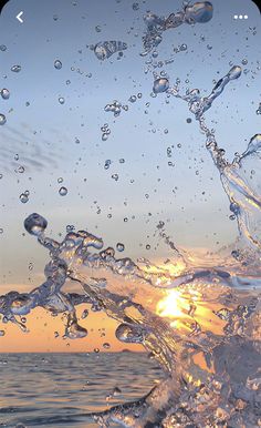 water splashing on the beach at sunset