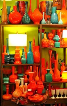 a shelf filled with lots of different colored vases on top of it's shelves