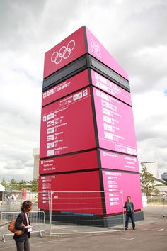 a tall red building with the olympic symbols on it