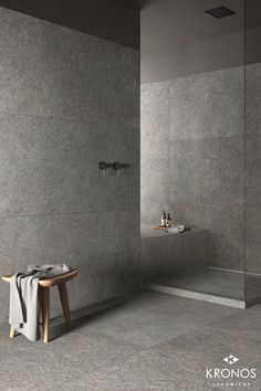 a bathroom with grey walls and floor tiles