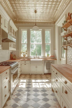 a kitchen with white cabinets and checkered tile flooring on the walls, along with an open window