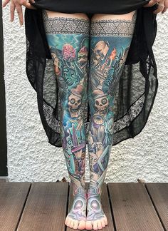 a woman's legs with tattoos on them