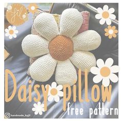 a crocheted daisy pillow sitting on top of a black leather chair with the words daisy pillow free pattern