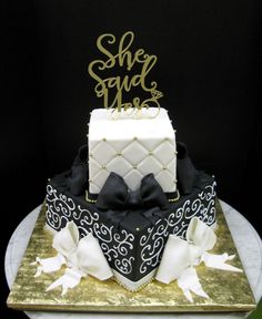 a black and white cake on a gold platter