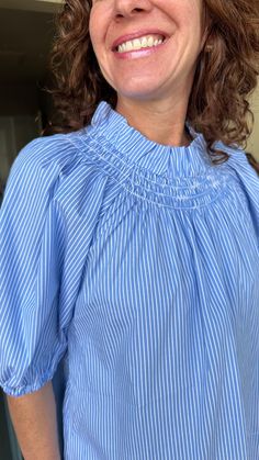 The Brooke Top in Blue Stripe is perfect for spring! Featuring a smocked neck, puff sleeves with an elastic elbow, and a flowy bodice, the Brooke Top remains a tried and true style! One size fits a 4-12 best. 100% cotton. Machine wash gentle cycle, hang to dry. Cathleen is 5'4" and usually wears a small (2/4) in tops. Long Sleeve Smocked Top For Daywear In Spring, Long Sleeve Smocked Top For Spring Daywear, Blue Balloon Sleeve Blouse For Daywear, Daywear Smocked Top With Gathered Long Sleeves, Long Sleeve Smocked Top With Gathered Sleeves For Daywear, Spring Daywear Blouse With Elastic Sleeves, Spring Blouse With Elastic Sleeves For Daywear, Blue Blouse With Gathered Sleeves For Daywear, Spring Blouse With Smocked Bodice And Bishop Sleeves