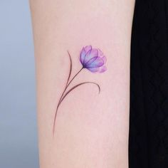 a small purple flower on the left side of the arm, with watercolors