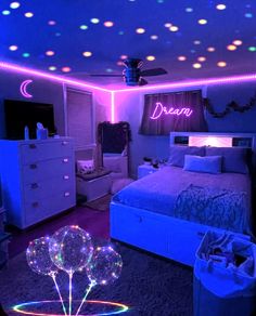 a bedroom with purple and blue lights on the ceiling