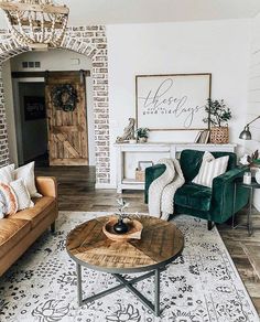 a living room with two couches, a coffee table and a chandelier