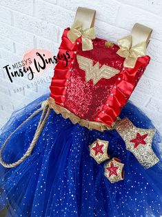 This set comes with the dress, cuffs, and headpiece ! The bodice is made with red sequin and lined with red satin , embroidered with the Wonder Woman logo, with detailed ribbon and pearls ! The skirt is made with tulle and and underlying skirt to hide from seeing underneath ! A rope is attached as well for the realistic detail! Thank you for shopping MTW! Please reach out if you have any questions ! Red Princess Costume Dress, Fitted Red Princess Costume, Red Sequined Dress For Dress-up Occasions, Red Sequined Dress-up Dresses, Red Sequined Dresses For Dress-up, Red Sequined Dress For Formal Events, Red Princess Costume For Costume Party, Red Princess Costume For Fancy Dress, Red Tulle Dress For Fancy Dress Occasions