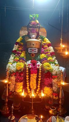 the idol is adorned with flowers and candles for diwaling or offering to people