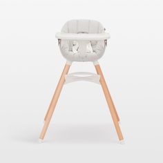 a white high chair with wooden legs on a white background in the shape of a baby's seat